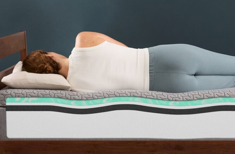 Woman sleeping on layered memory foam mattress