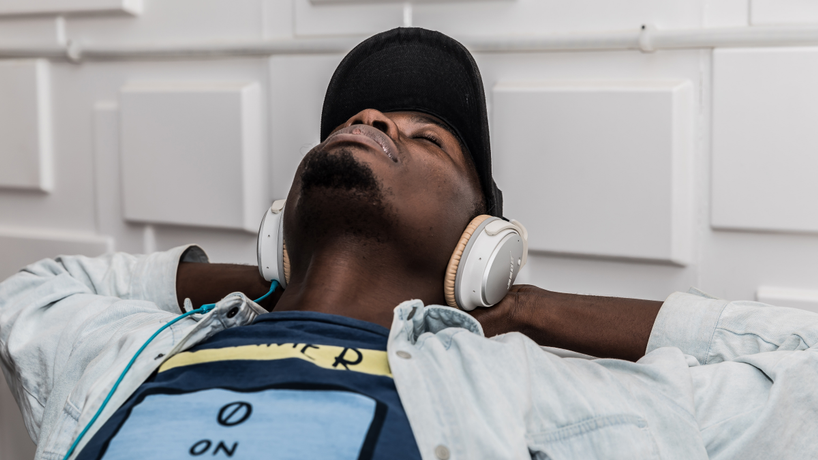 Person relaxing with white headphones