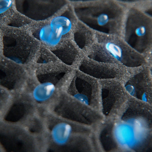 Close-up of porous material with blue droplets