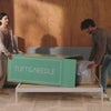 Couple unpacking mattress in modern bedroom