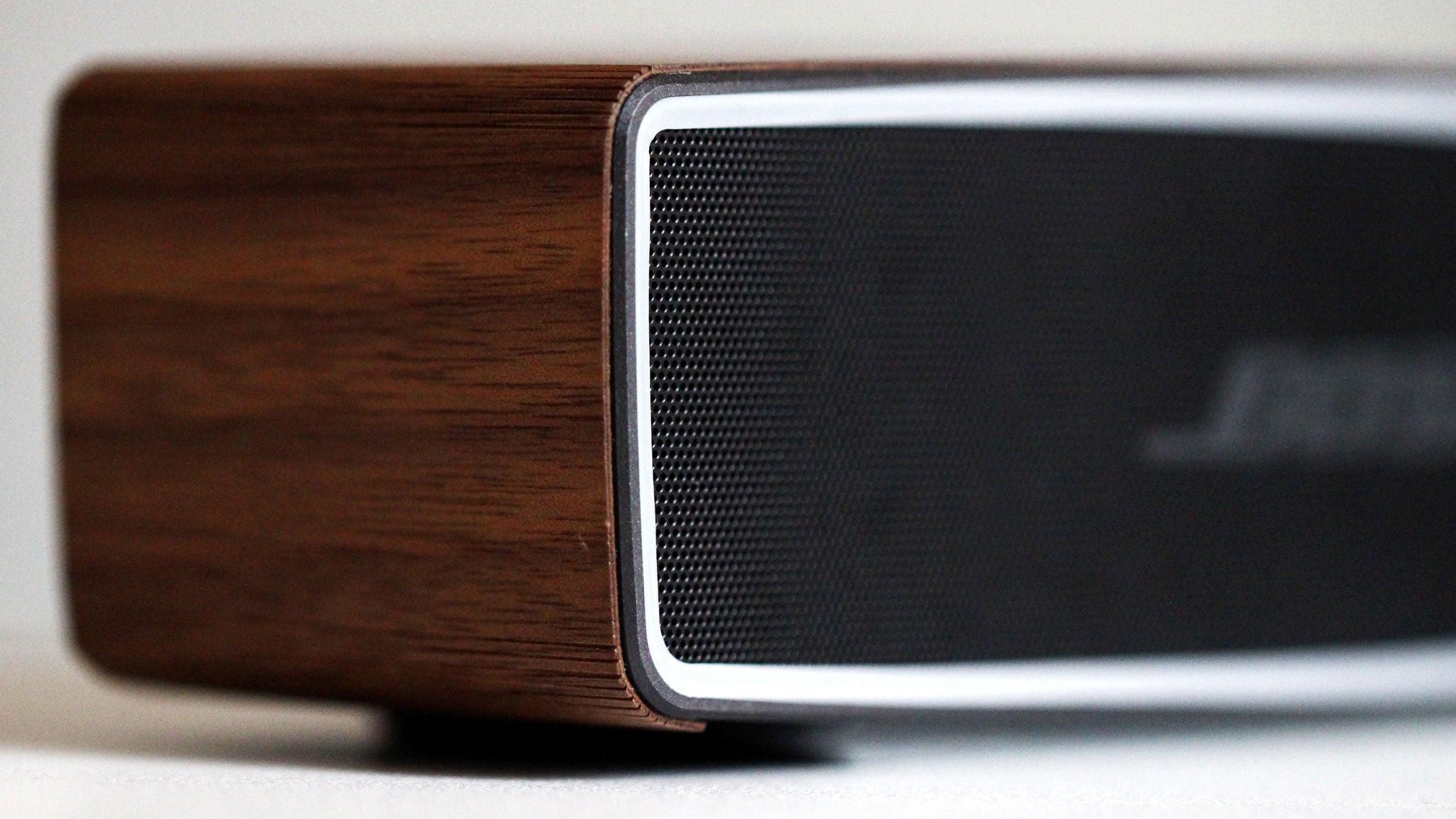 Wooden speaker with sleek black grille