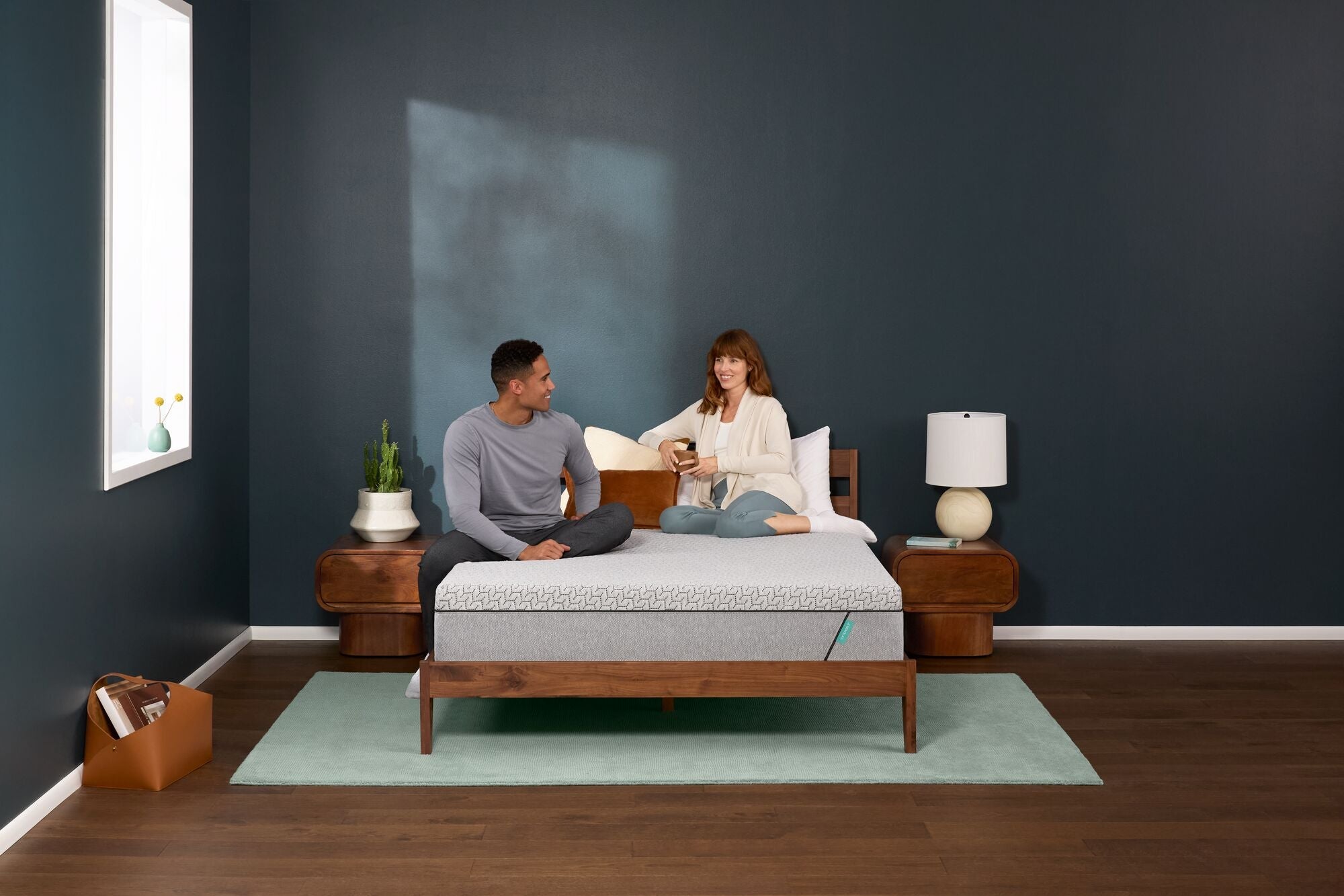 Couple relaxing on modern bed in bedroom