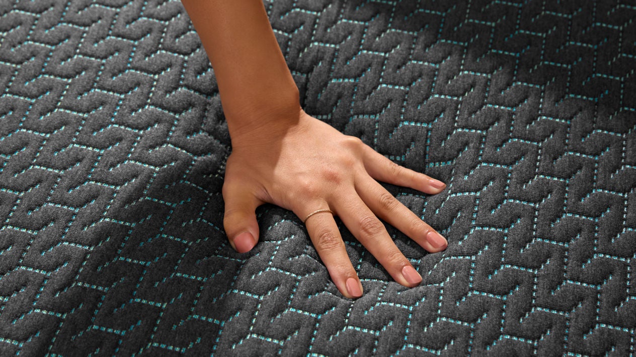 Hand pressing textured mattress surface