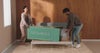 Couple Moving Green Cardboard Box Indoors