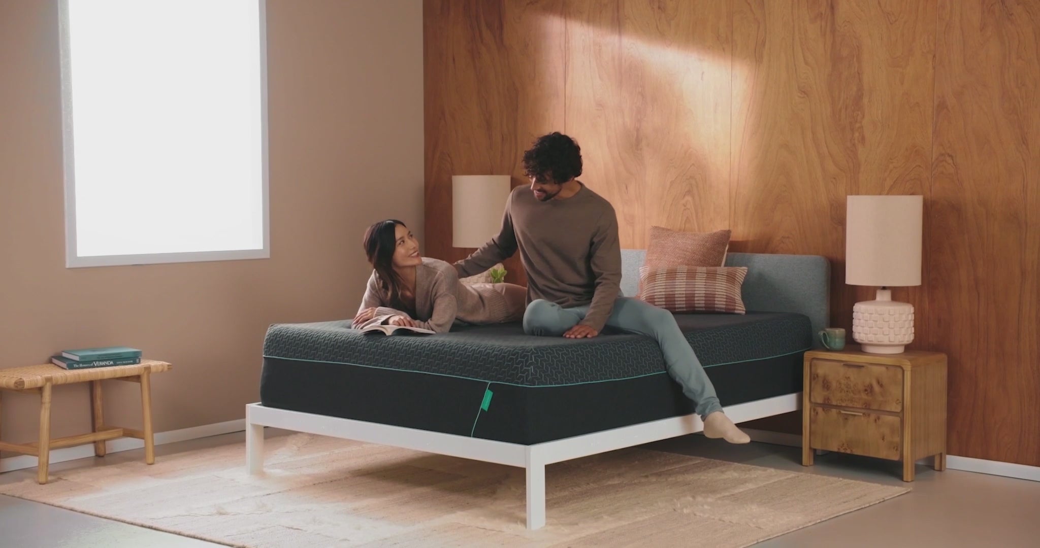Couple relaxing on modern mattress in cozy room