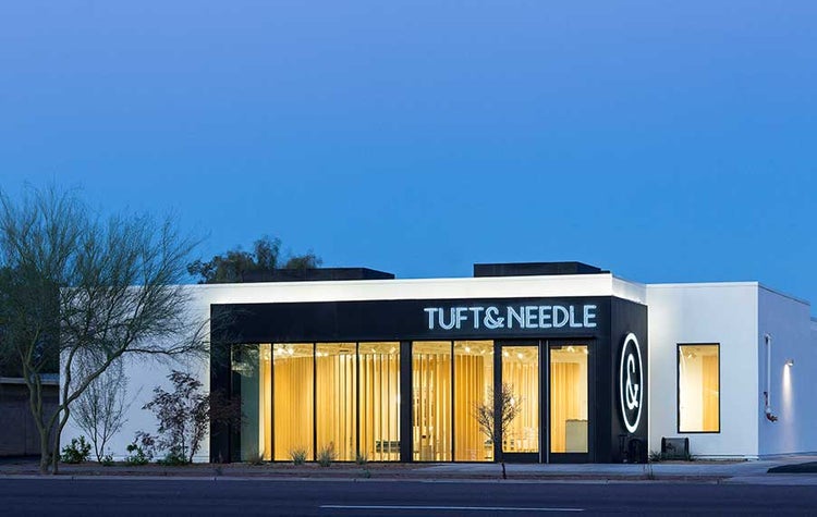 Tuft & Needle storefront at dusk