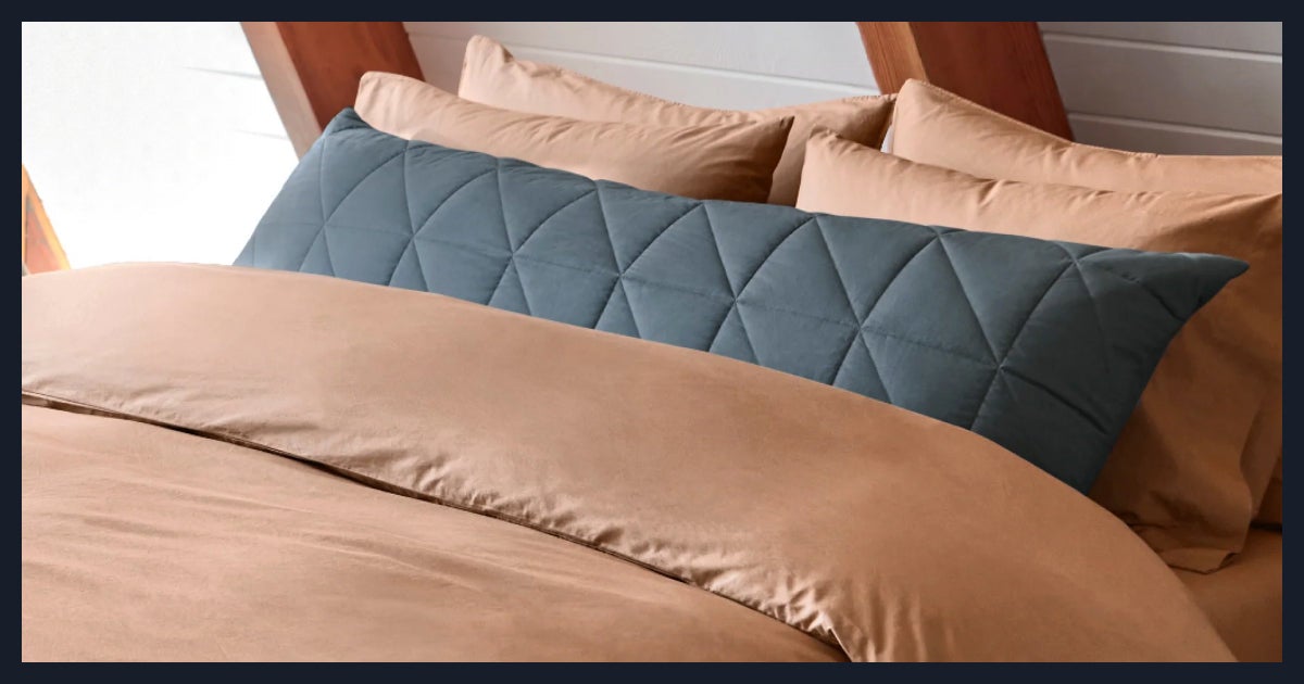 Beige bedding with blue quilted pillow