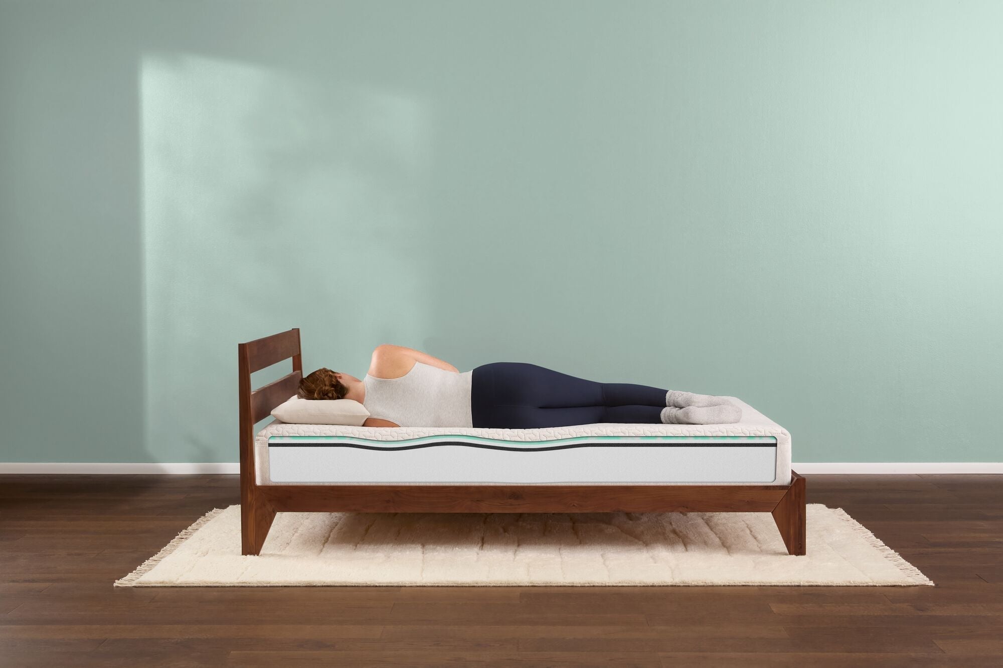 Woman sleeping on modern wooden bed