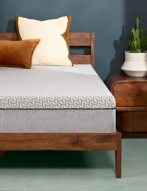 Modern bed with gray mattress and pillows