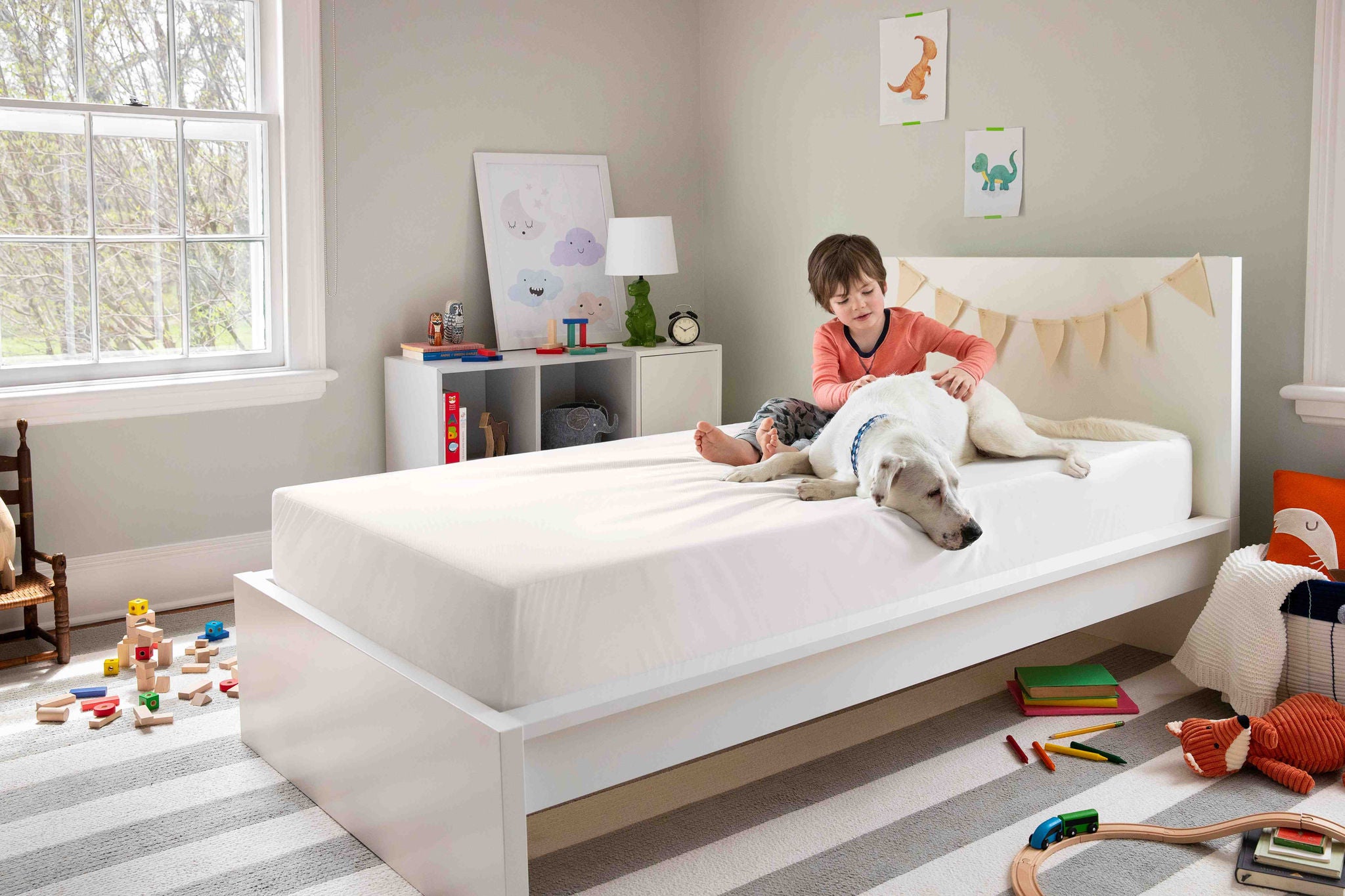 Child relaxing with dog in cozy bedroom