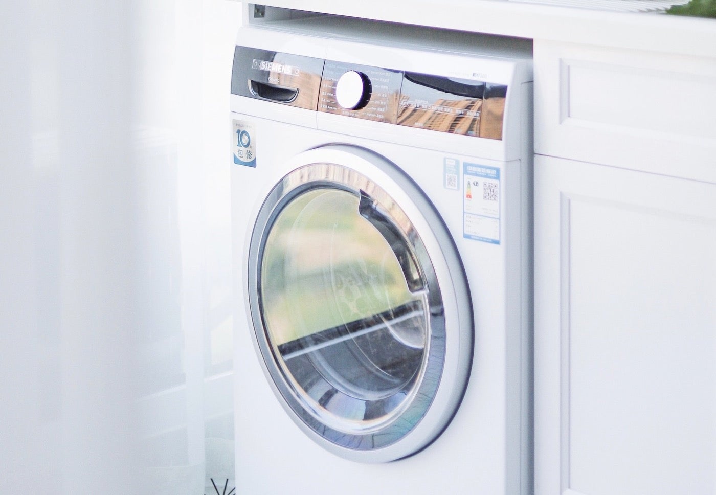 Modern front-load washing machine in bright setting