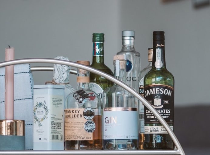 Assorted liquor bottles on a bar cart