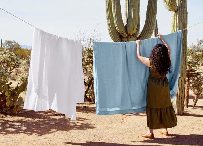 Woman hanging laundry in desert setting