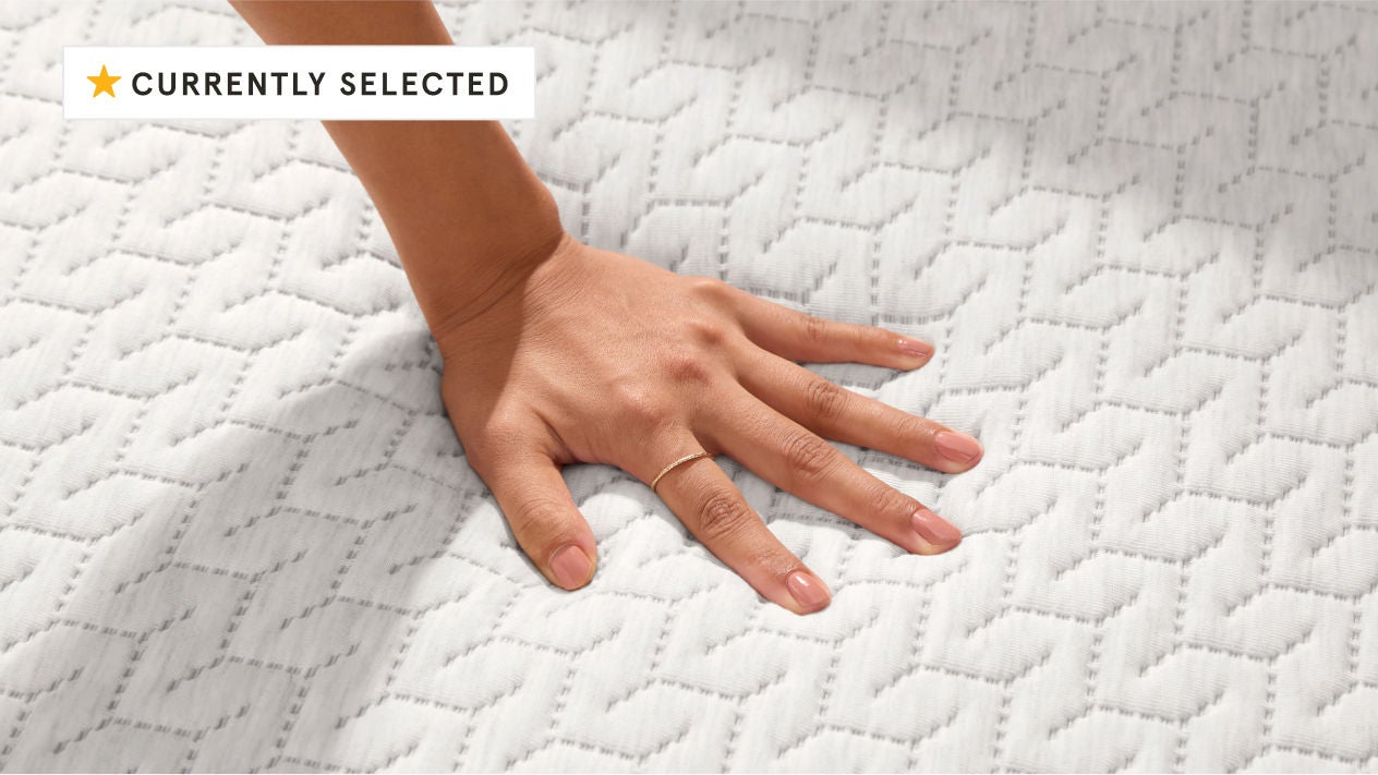 Hand pressing textured white mattress