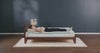 Woman relaxing on modern wooden bed