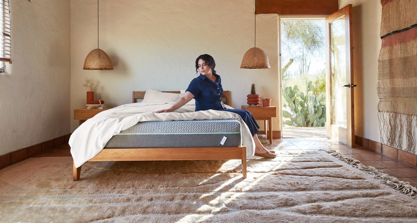 Woman in serene bedroom with modern decor