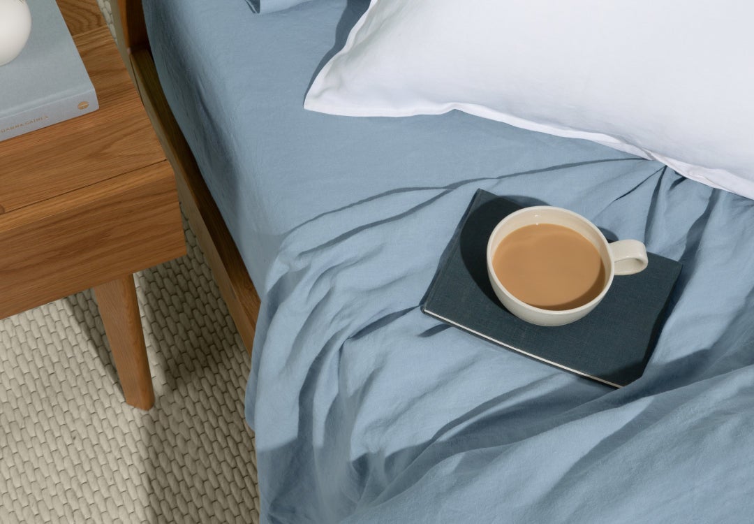 Cup of tea on a cozy bed