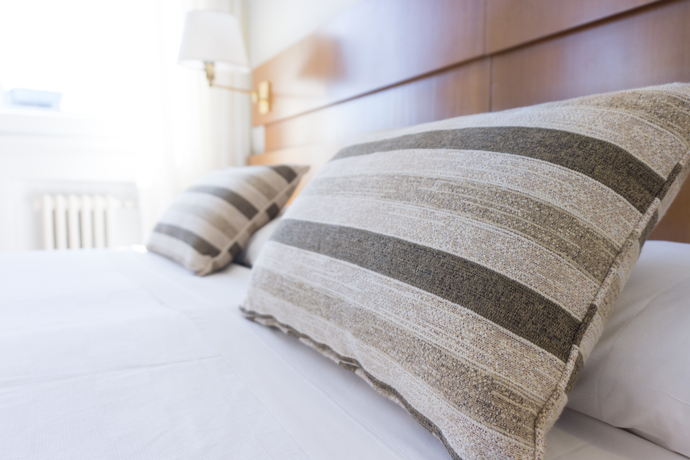 Striped pillows on neatly made bed