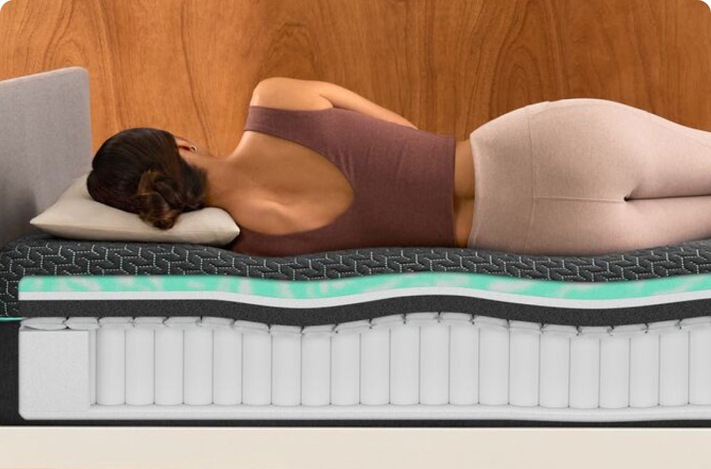 Woman sleeping on layered mattress cutaway