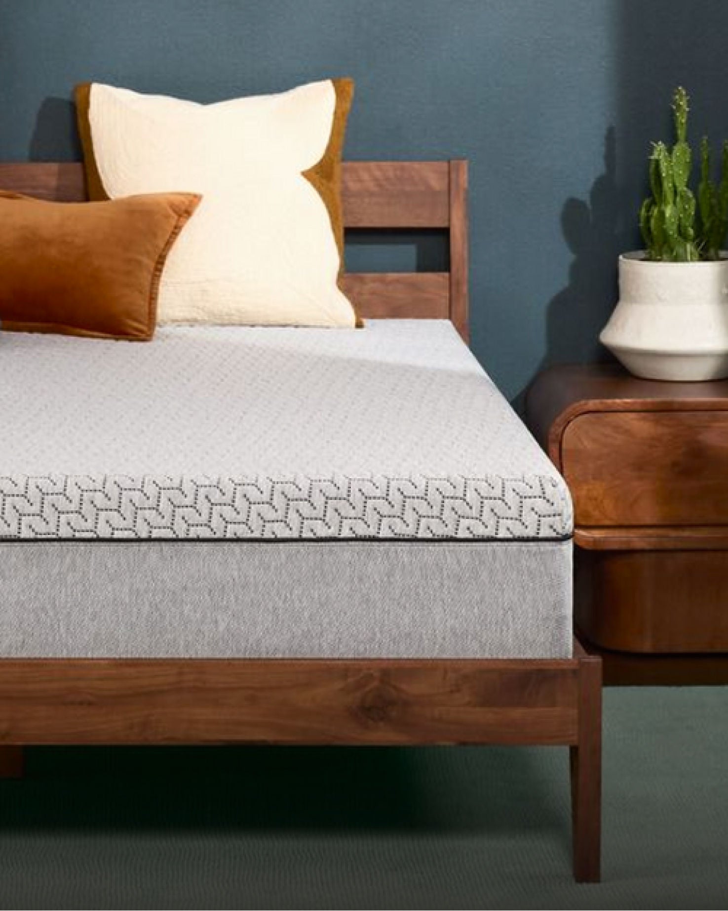 Modern bed with gray mattress and pillows